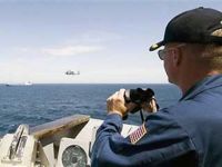 Sept. 30: Commanding officer of a U.S. Navy guided-missile cruiser monitors the pirated Ukrainian cargo ship Faina in the Indian Ocean. 