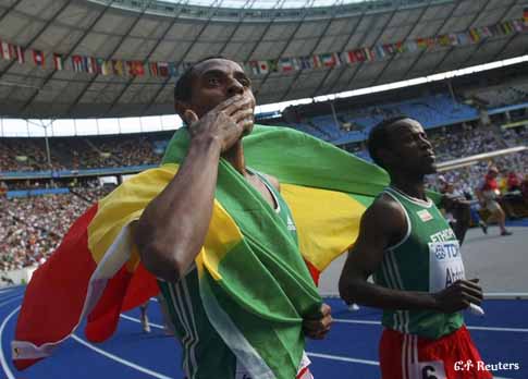Kenenisa Bekele of Ethopia (L) and campatriot Ali Abdosh hold up their national flag as they celebrate after the men's 5000 metres at the world athletics championships at the Olympic stadium in Berlin August 23, 2009. Kenenisa Bekele of Ethopia (L) and campatriot Ali Abdosh hold up their national flag as they celebrate after the men's 5000 metres at the world athletics championships at the Olympic stadium in Berlin August 23, 2009.